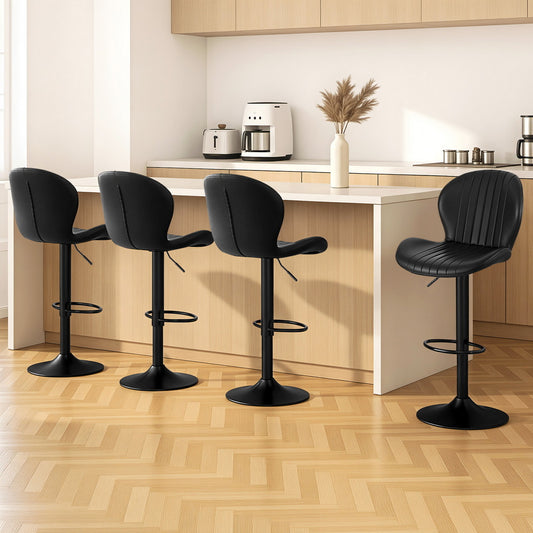 Four black bar stools in a kitchen setting with wooden flooring and white walls.