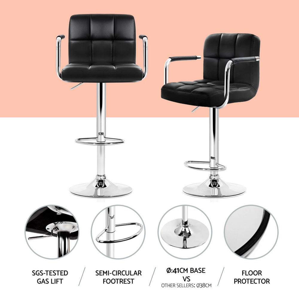 Two black bar stools with chrome legs on a white background