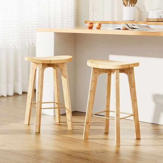 Two wooden stools in a room with a table and decor items.