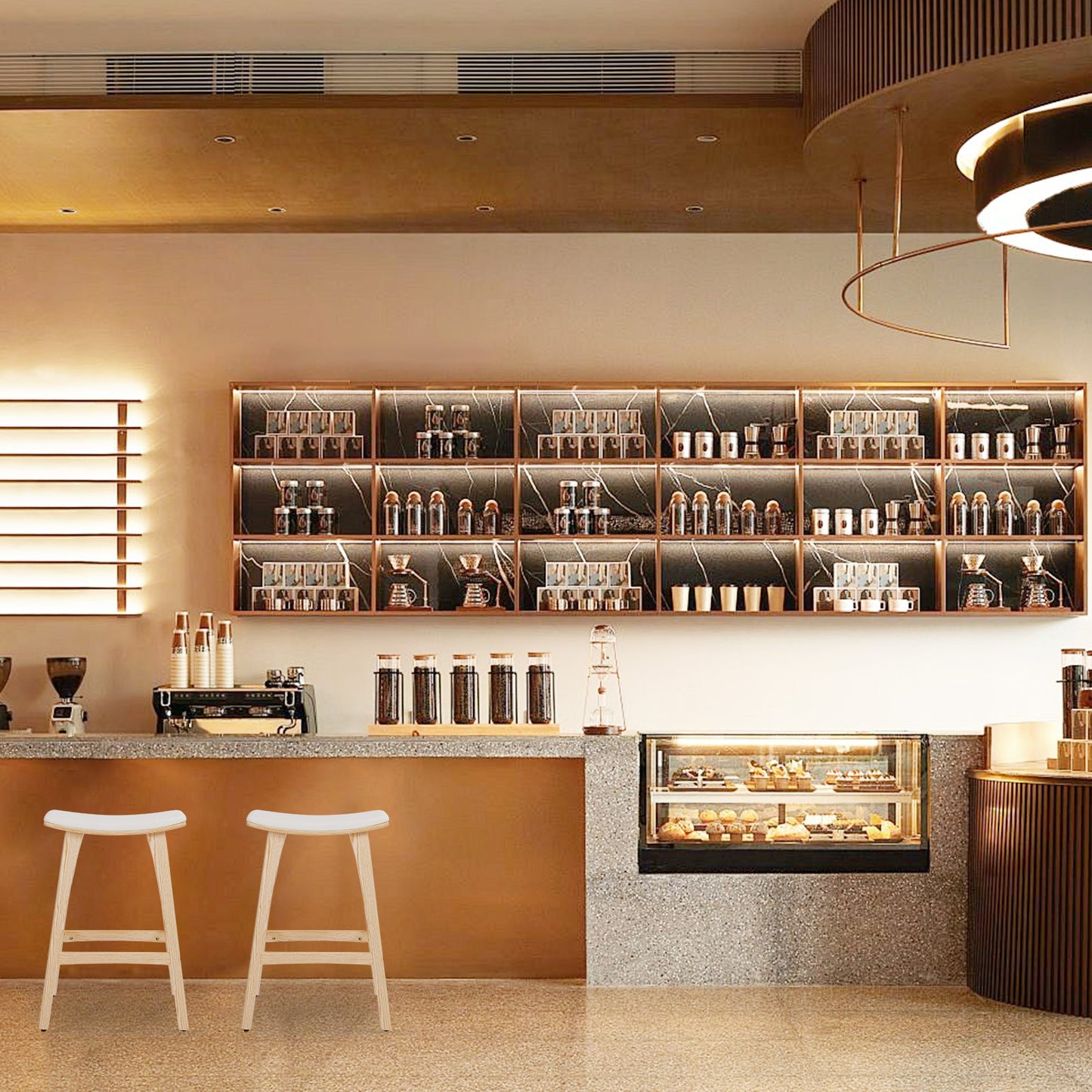 Modern cafe interior with shelves, counter, and stools.
