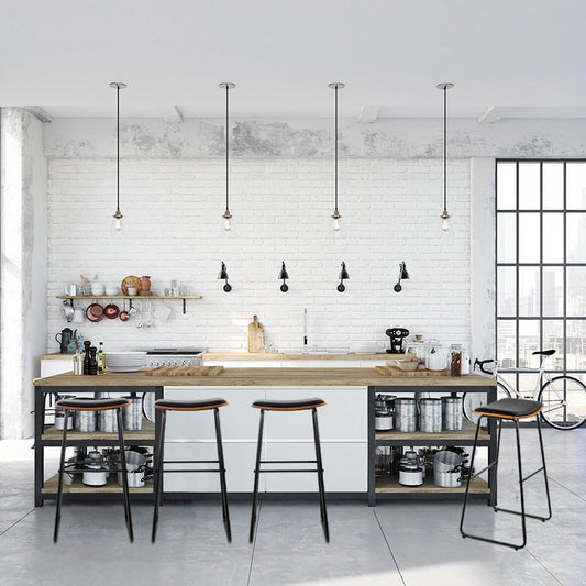 Modern kitchen with wooden island, bar stools, and pendant lights.