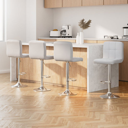 Four white bar stools with metal legs in a modern kitchen setting.