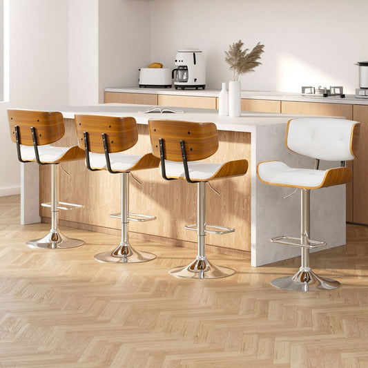 Modern kitchen with bar stools and a white island.