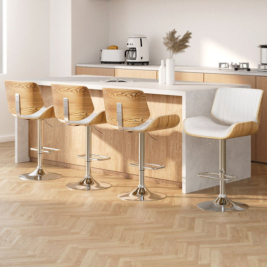 Modern kitchen with wooden stools and a white island.