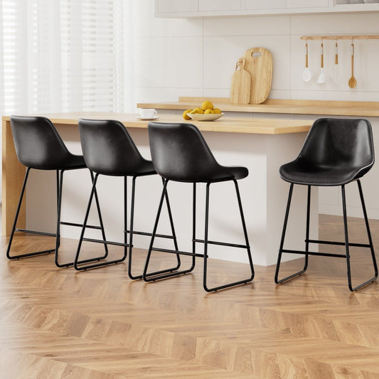 Four black bar stools in a kitchen setting with wooden flooring and a countertop.