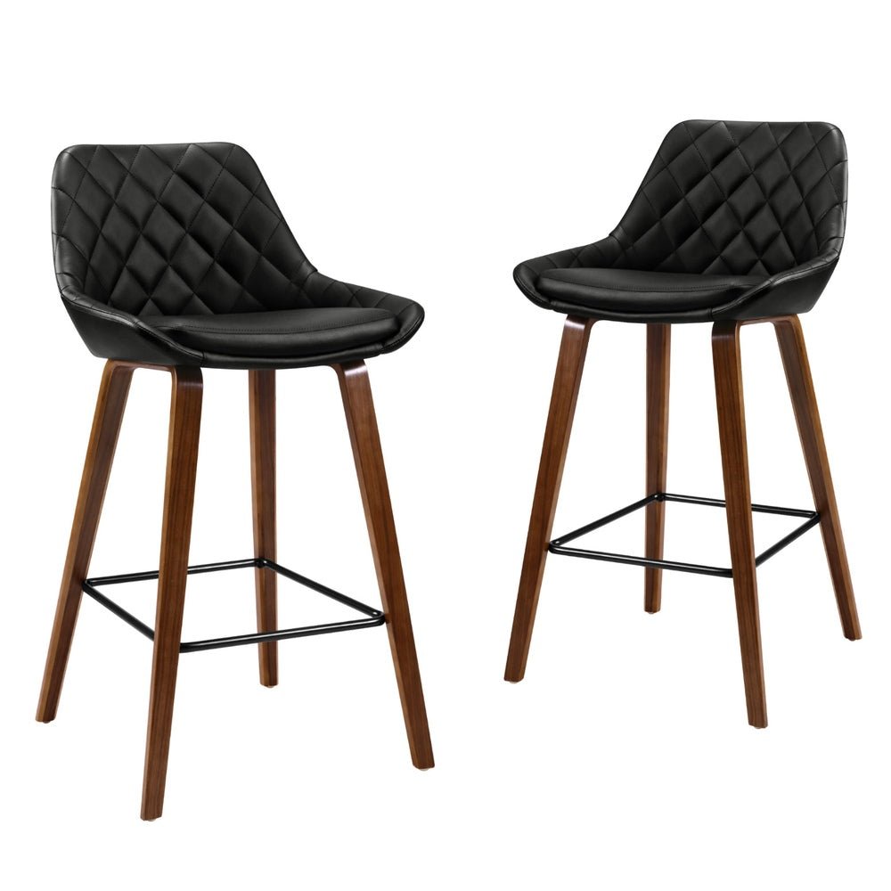 Two leather bar stools with timber frames on a white background