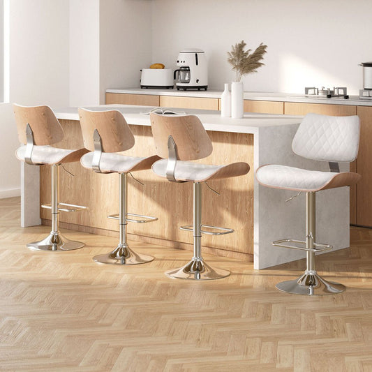 Modern kitchen with four bar stools and a light wood floor.