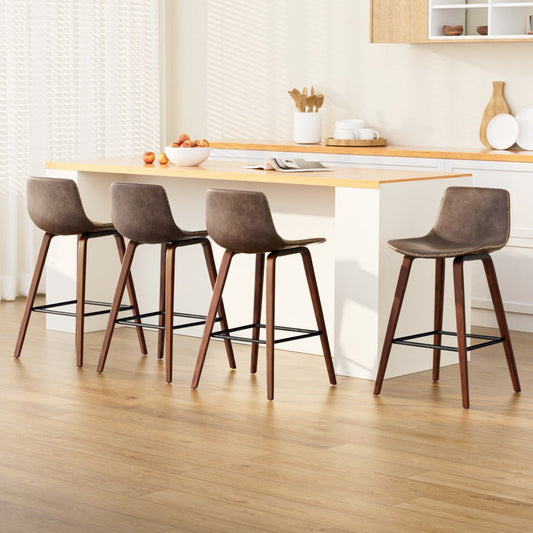 Four brown bar stools in front of a wooden dining table with a neutral color scheme.