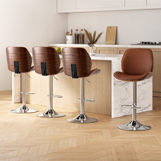 Four brown bar stools with metal legs in a kitchen setting.