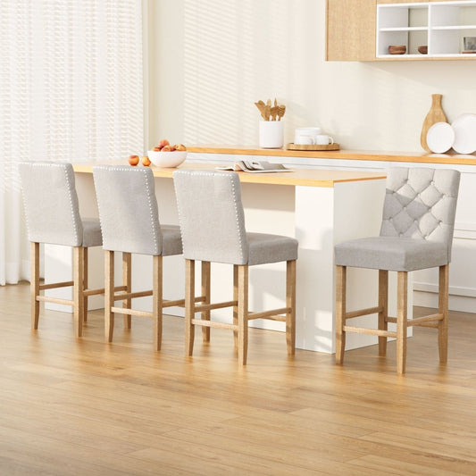 Four beige upholstered bar stools with wooden legs in front of a kitchen island bench