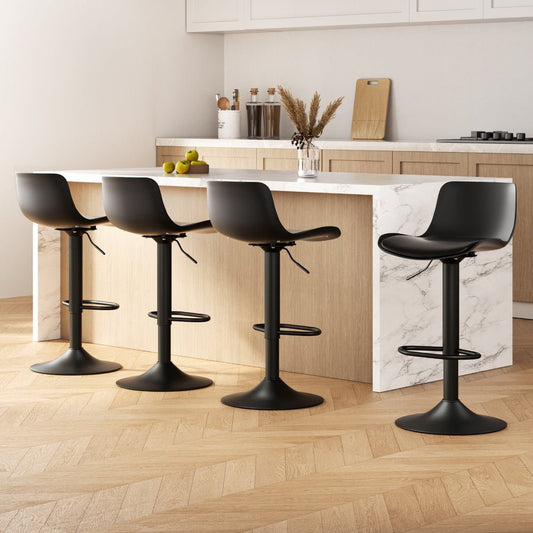Black bar stools in a modern kitchen setting with marble island and wooden floor.