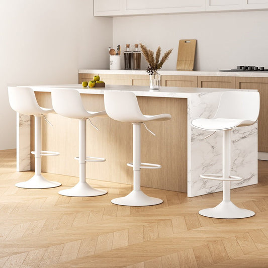 White bar stools in a modern kitchen setting with marble island and wooden floor.