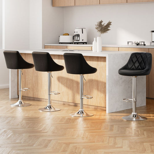 Modern kitchen with black bar stools and a white countertop.