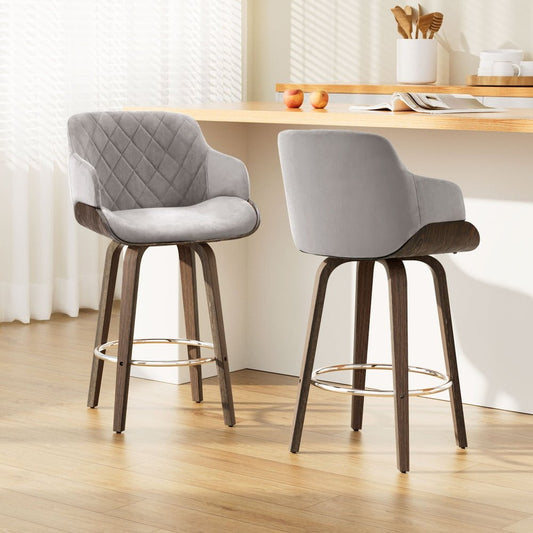 Two grey bar stools with wooden legs in a kitchen setting