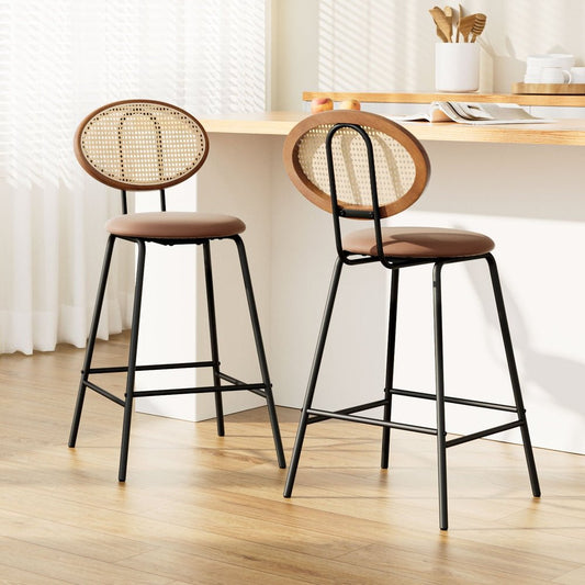 Two bar stools with woven backrests in a kitchen setting.