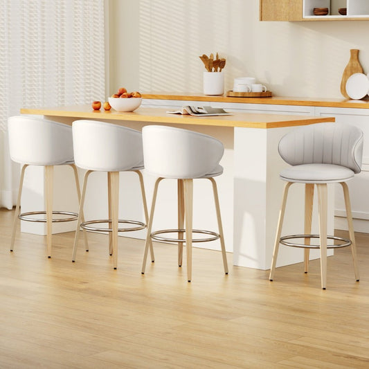 Modern kitchen with wooden table and stools on a light wood floor.