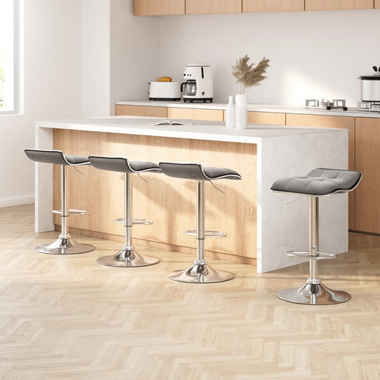 Modern kitchen with a white island and four grey bar stools