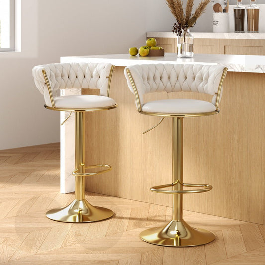Two white bar stools with gold legs in a kitchen setting.