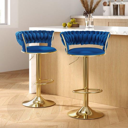 Two blue bar stools with gold legs in a kitchen setting.
