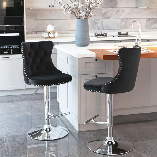 Two black bar stools with chrome bases in a kitchen setting