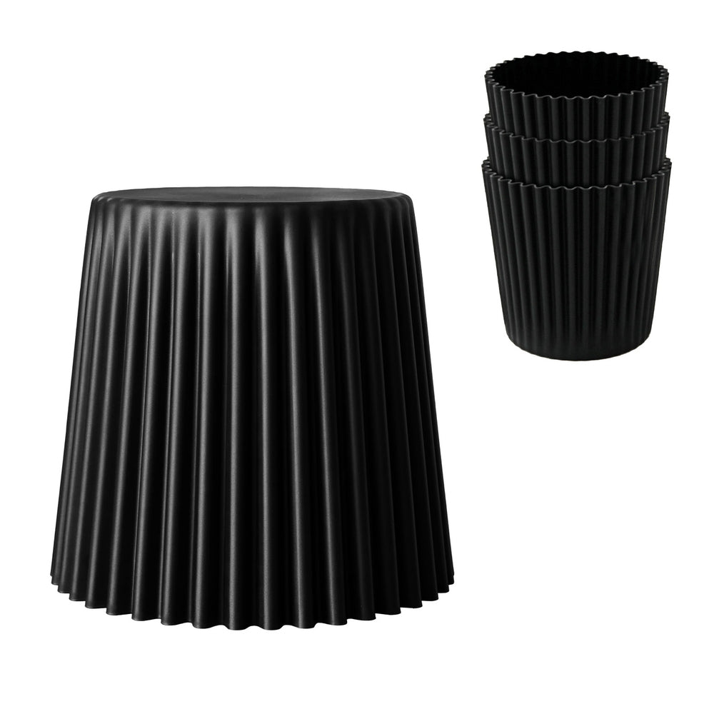 Black pleated stool and 3 black plastic stacked tools on a white background