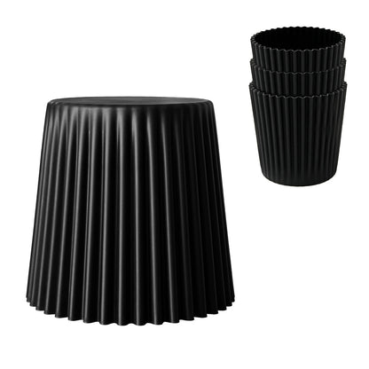 Black pleated stool and 3 black plastic stacked tools on a white background