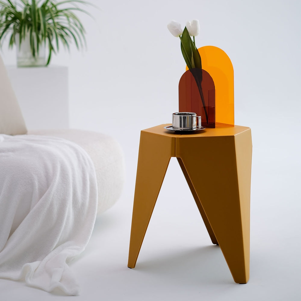 Modern side table with a geometric design in a minimalistic room.