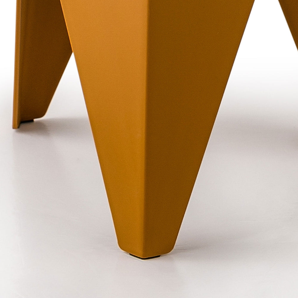 Close-up of a mustard yellow chair leg on a white background