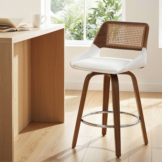 Modern bar stool with wooden frame and white seat next to a wooden table in a bright room.