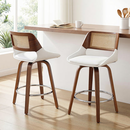 Two bar stools with wooden frames and white seats in a kitchen setting.