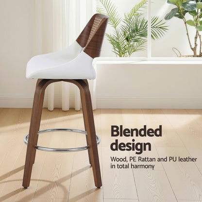 Bar stool with white seat and wooden legs in a room with plants