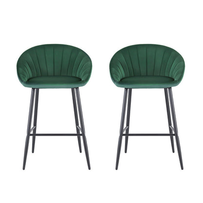 Two green bar stools with black metal legs on a white background
