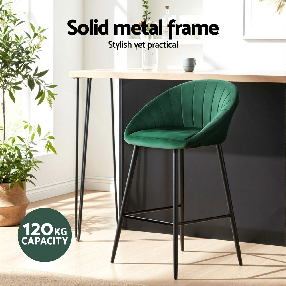 Green bar stool with black metal frame in a modern kitchen setting