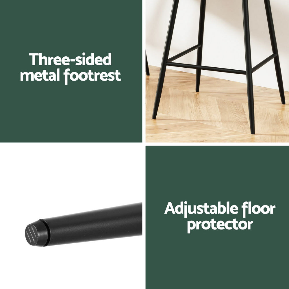 Three-sided metal footrest and adjustable floor protector with a stool on a wooden floor.