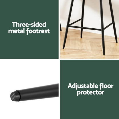 Three-sided metal footrest and adjustable floor protector with a stool on a wooden floor.