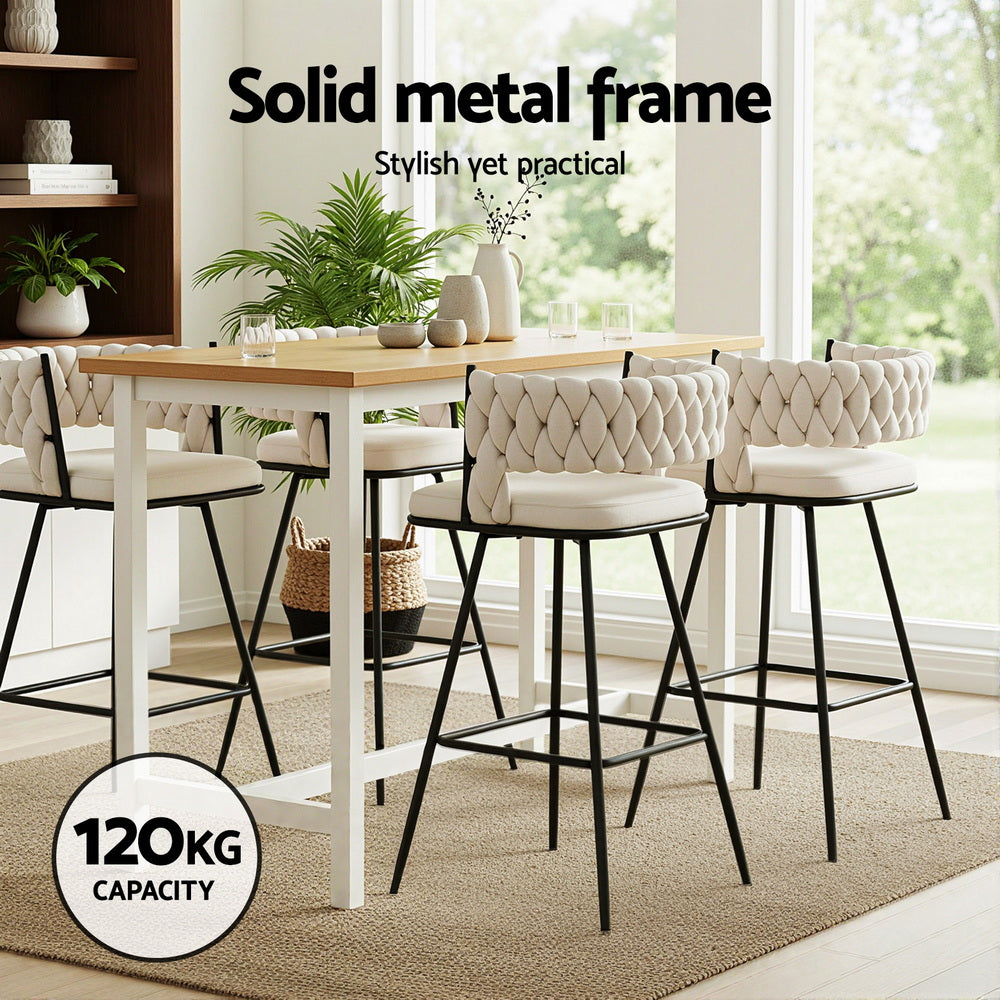 Dining table with chairs in a bright room with large windows, featuring text about a solid metal frame.