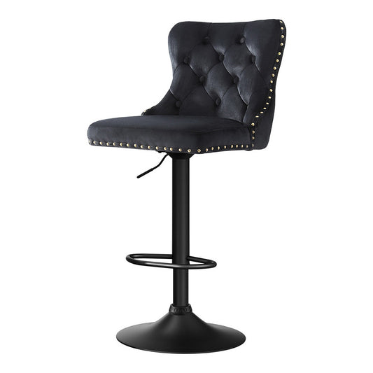 Black bar stool with tufted seat and nailhead trim on a white background
