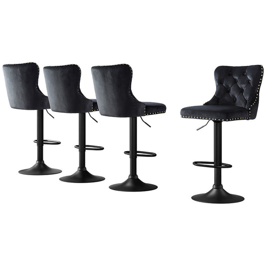 Set of four black bar stools with tufted seats on a white background