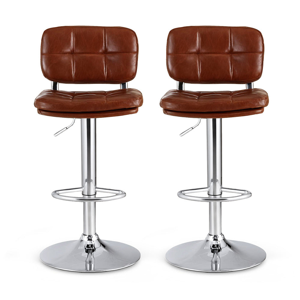 Two brown leather bar stools with chrome bases on a white background