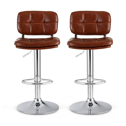 Two brown leather bar stools with chrome bases on a white background