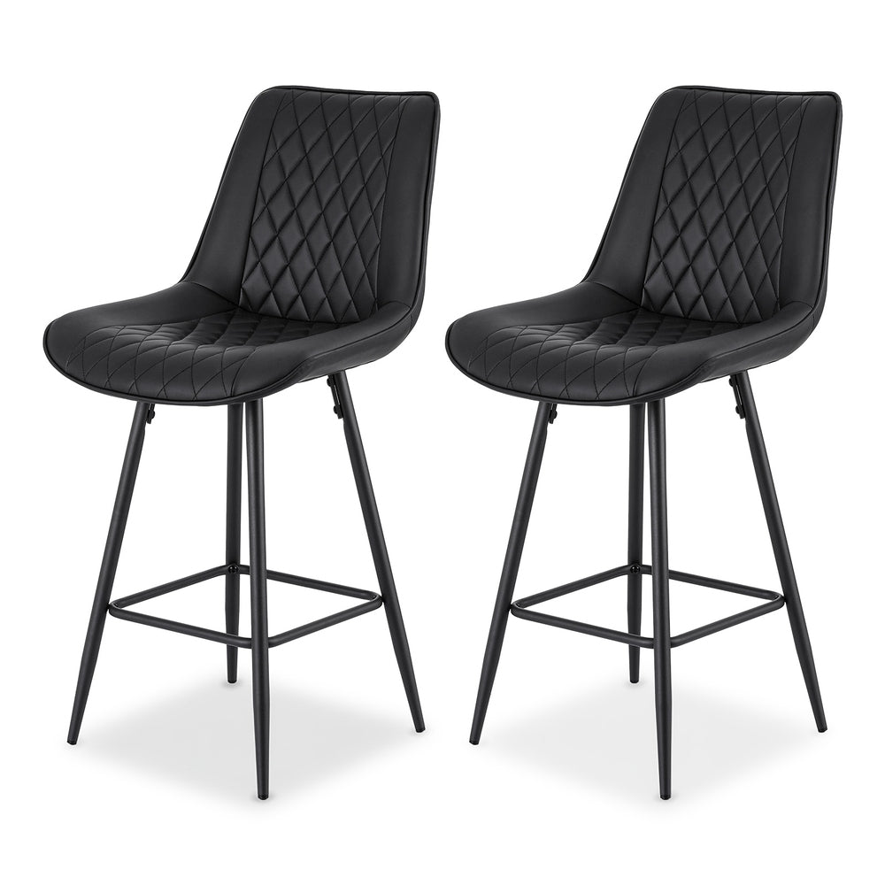 Two black bar stools with quilted seats on a white background