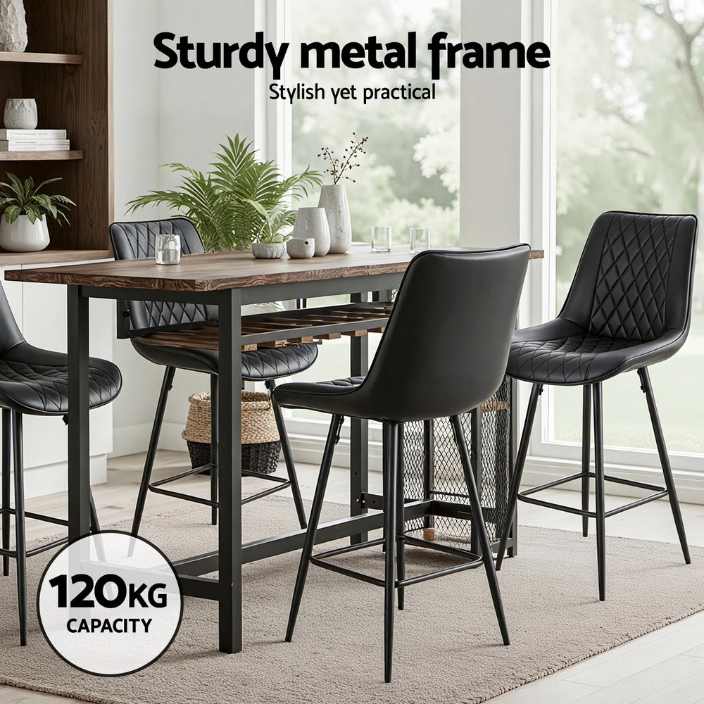 Dining table with black chairs in a modern kitchen setting, emphasizing a sturdy metal frame.