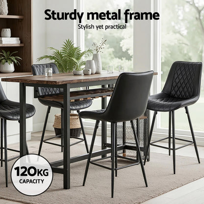 Dining table with black chairs in a modern kitchen setting, emphasizing a sturdy metal frame.