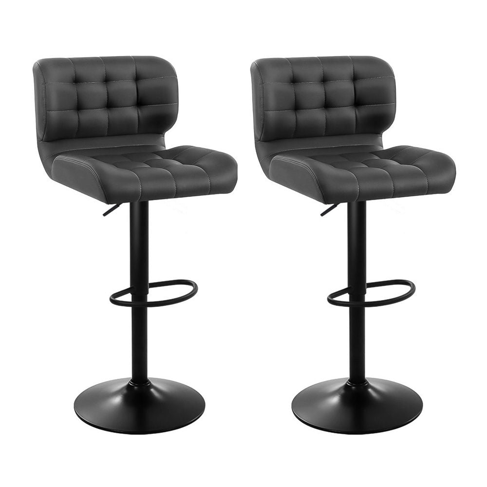 Two black bar stools with tufted seats on a white background
