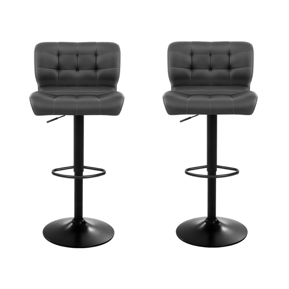 Two black bar stools with black metal bases on a white background