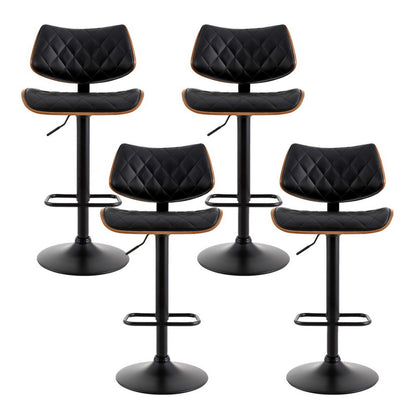 Four black quilted bar stools with wooden accents on a white background