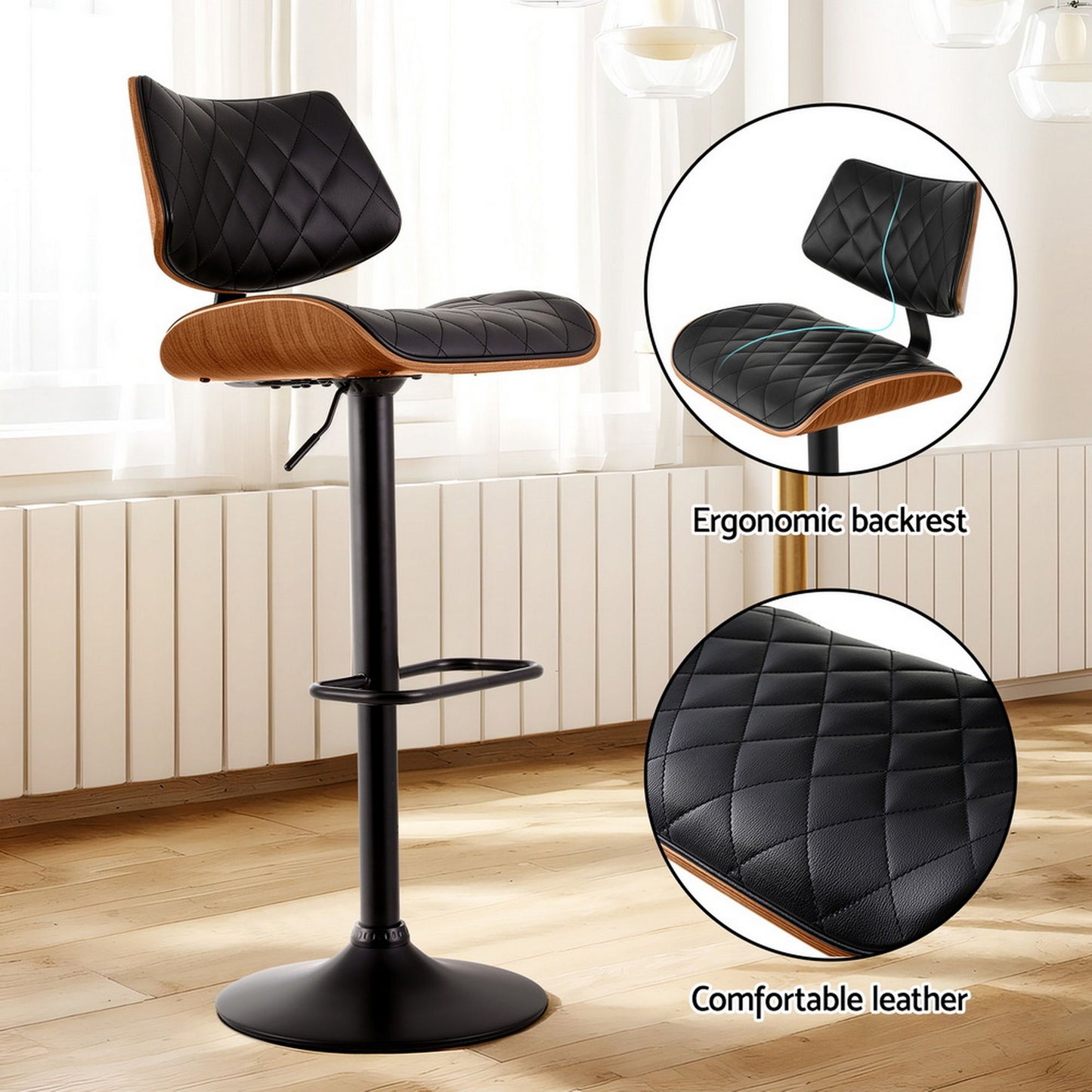 Bar stool with black quilted leather seat and wooden armrests on a wooden floor