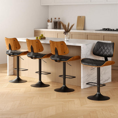 Four bar stools with black leather seats and wooden frames in a kitchen setting