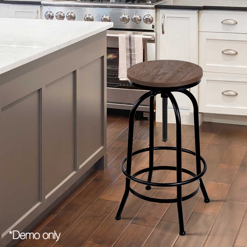 Wooden bar stool with black metal legs in a kitchen setting