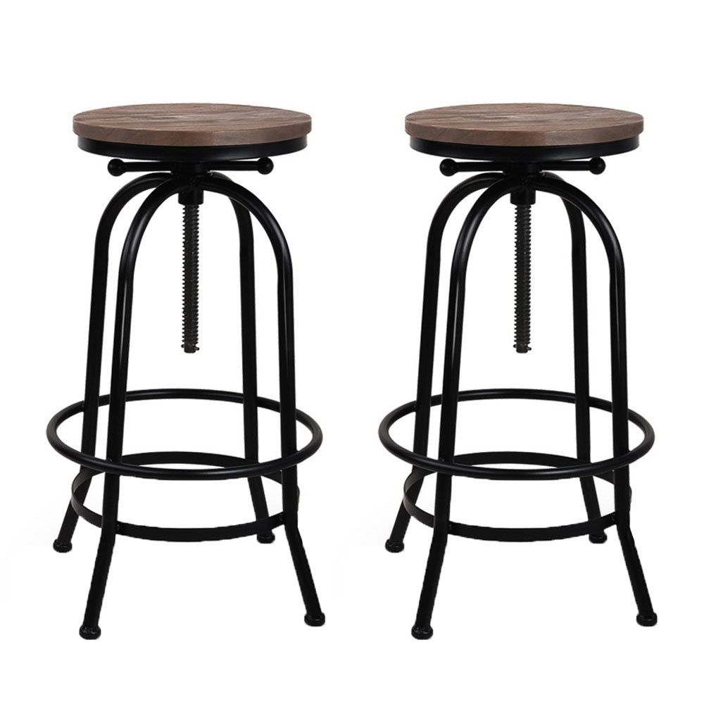 Two bar stools with wooden seats and black metal frames on a white background